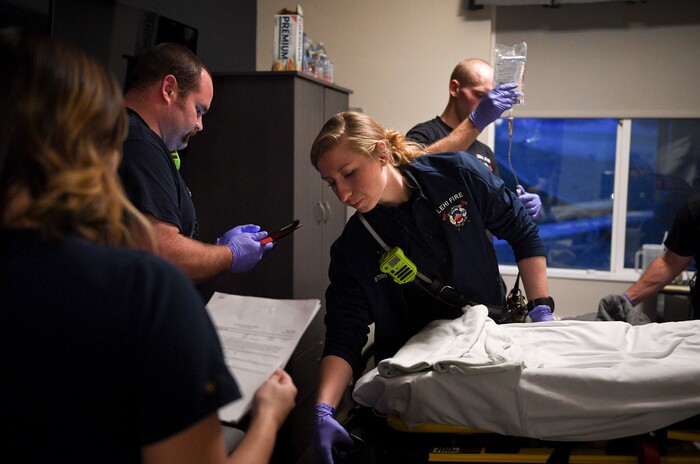 In this Jan. 19, 2018, photo, Lehi firefighter and paramedic Aubrey Freiberg works with fellow firefighters as they respond to a medical call at Pointe Meadows Health and Rehabilitation in Lehi, Utah. (Isaac Hale/The Daily Herald via AP)