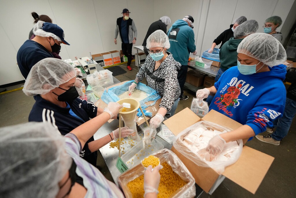 (Francisco Kjolseth | The Salt Lake Tribune) Employees of Progrexion credit repair law firm volunteer their time assembling food packets at the Utah Food Bank warehouse in South Salt Lake on Wednesday, Feb. 16, 2022. 