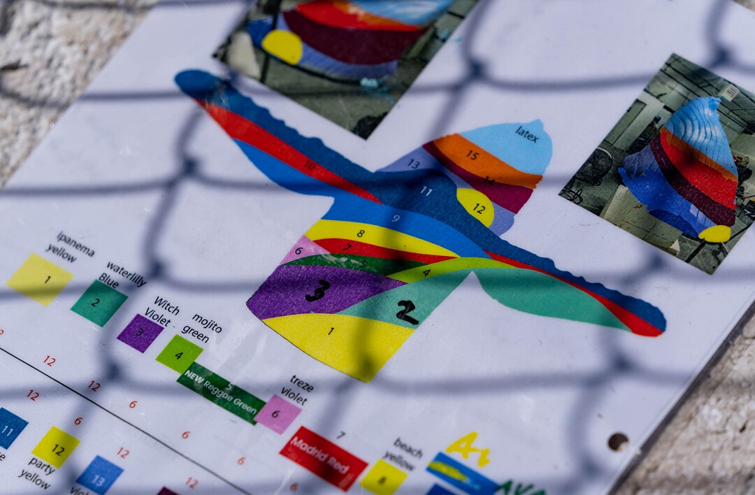 (Francisco Kjolseth | The Salt Lake Tribune) Local artist Mike Murdock follows his color plan as he begins his colorful transformation of “Out of the Blue,” by artist Stephen Kesler on Thursday, April 7, 2022. The full-sized sculpture of a humpback whale breaching from the roundabout at 900 South 1100 East will be inaugurated on Monday, April 11, 2022. 