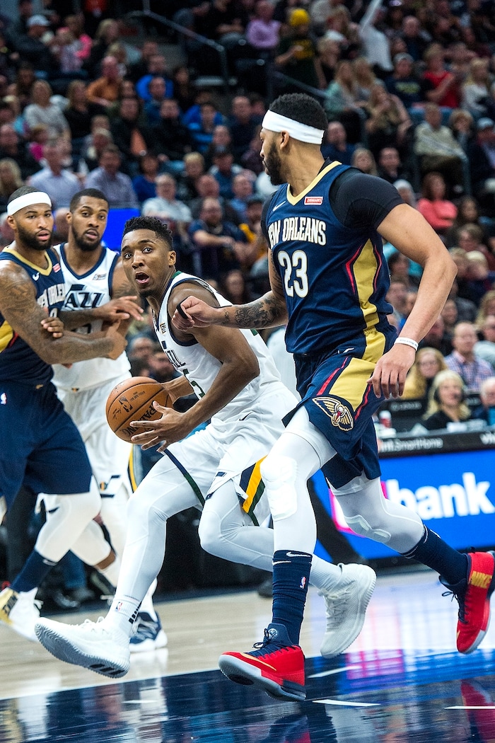 (Chris Detrick  |  The Salt Lake Tribune)  Utah Jazz guard Donovan Mitchell (45) runs past New Orleans Pelicans forward Anthony Davis (23) during the game at Vivint Smart Home Arena Friday, December 1, 2017.  