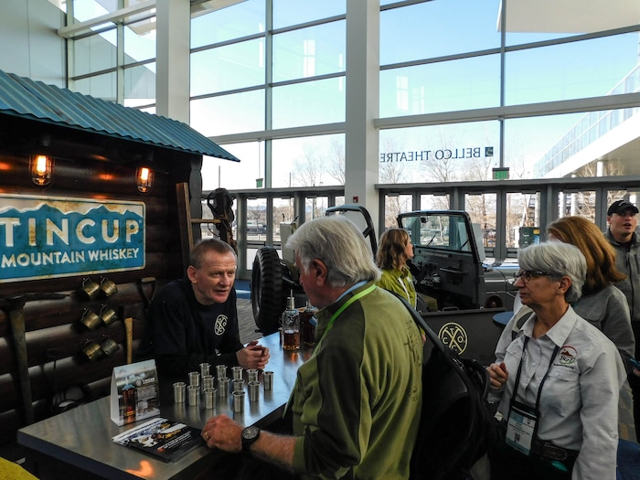 (Erin Alberty | The Salt Lake Tribune) A bartender serves samples of Tincup whiskey, at the Outdoor Retailer show Jan. 26, 2018 at the Colorado Convention Center in Denver.