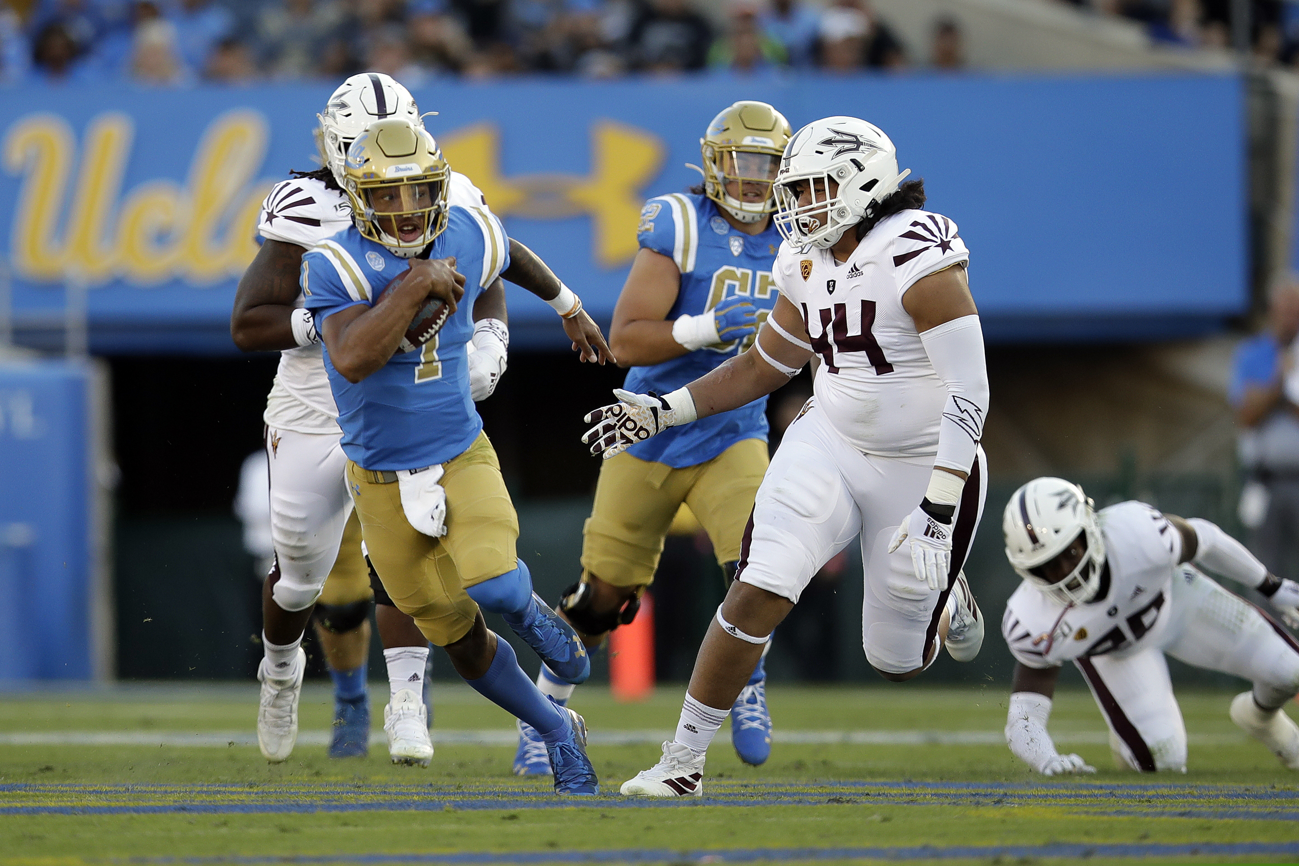 (Marcio Jose Sanchez | AP) UCLA quarterback Dorian Thompson-Robinson, shown running against Arizona State, will face Utah on Saturday at Rice-Eccles Stadium after missing last year's loss to the Utes due to injury,