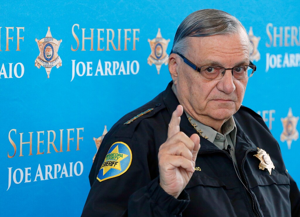 FILE - In this Dec. 18, 2013 file photo, Maricopa County Sheriff Joe Arpaio pauses as he answers a question at a news conference at Maricopa County Sheriff's Office Headquarters in Phoenix. Arpaio was convicted of a criminal charge Monday, July 31, 2017, for refusing to stop traffic patrols that targeted immigrants, marking a final rebuke for a politician who once drew strong popularity from such crackdowns but was ultimately booted from office as voters became frustrated over his headline-grabbing tactics and deepening legal troubles. (AP Photo/Ross D. Franklin, File)