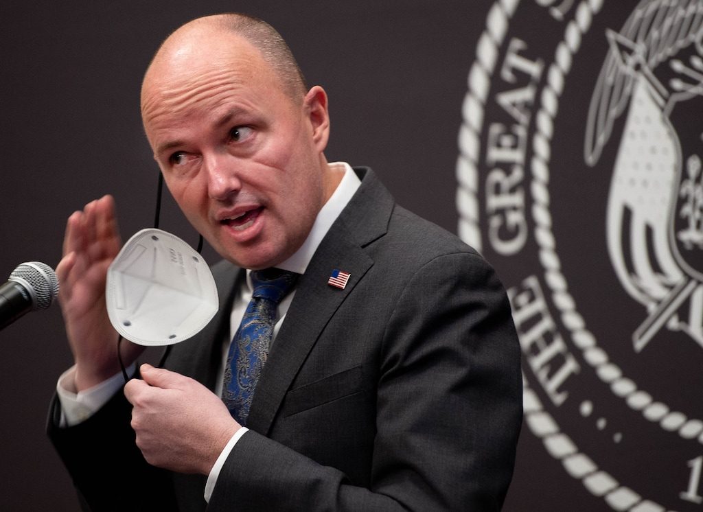 (Francisco Kjolseth  | The Salt Lake Tribune) Gov. Spencer Cox removes his mask at a news conference on Feb. 25, 2021. Cox issued an executive order on May 13, 2021, that said Utah school districts could stop requiring masks for the last week of the school year — which is next week for Bear River Middle School in Tremonton, where faculty and students marked the shift with a celebratory mask burning Friday after school.