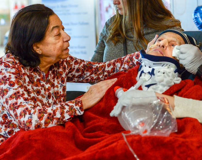 Leah Hogsten  |  The Salt Lake Tribune  l Lucia Silva caresses the face of her husband, Osvaldo Silva. On Friday, Intermountain Hospital caregivers wheeled paralyzed cancer patient Osvaldo Silva, 85, down to the lobby for a personal piano concert in his honor, Feb. 15, 2019. With tears streaming down his face, Osvaldo, who is from Brazil, was treated to a dozen songs played by his Church of Jesus Christ of Latter-day Saints bishop, Bispo Do Pai Valdir, who kicked off the set with none other than ÒThe Girl from Ipanema.Ó  