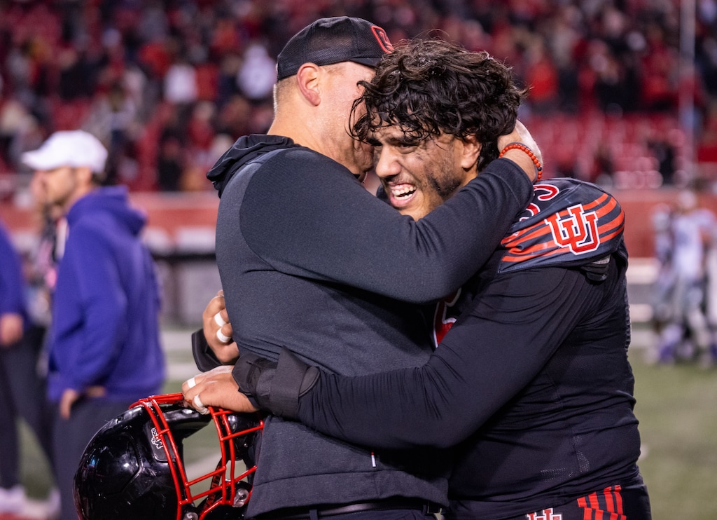 (Rick Egan | The Salt Lake Tribune) Utah Jim Harding assistant coach hugs offensive lineman Spencer Fano (55) as they celebrate the Utes' win over Kansas State.

