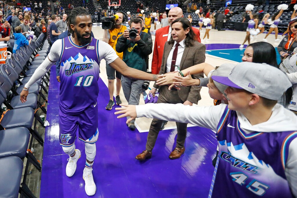 (Rick Bowme | AP) Utah Jazz guard Mike Conley receives high-fives from fans as he leaves the court following the team's NBA basketball game against the Los Angeles Clippers on Wednesday, Oct. 30, 2019, in Salt Lake City.