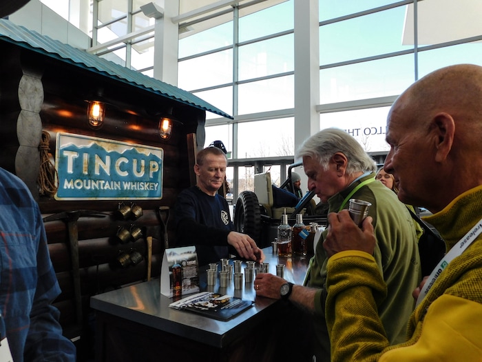(Erin Alberty | The Salt Lake Tribune) A bartender serves samples of Tincup whiskey, at the Outdoor Retailer show Jan. 26, 2018 at the Colorado Convention Center in Denver.