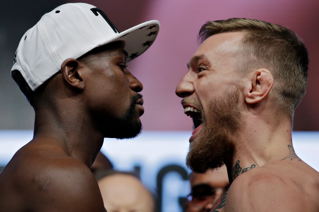 Floyd Mayweather Jr., left, and Conor McGregor face off during a weigh-in Friday, Aug. 25, 2017, in Las Vegas. The two are scheduled to fight in a boxing match Saturday in Las Vegas. (AP Photo/John Locher)