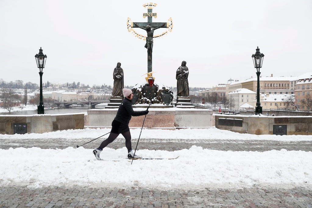 (Petr David Josek | The Associated Press) A woman skis across the medieval Charles Bridge after a heavy snowfall in Prague, Czech Republic, Tuesday, Feb. 9, 2021.