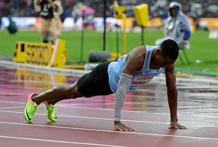 Botswana's Isaac Makwala does press-ups on the track after finishing a Men's 200m individual time trial during the World Athletics Championships in London Wednesday, Aug. 9, 2017. Makwala ran an individual time trial to qualify for the 200m semi-finals after he missed the 200m heats and the 400m final as he was barred from competing for 48 hours while organisers tried to halt a norovirus outbreak. (AP Photo/David J. Phillip)