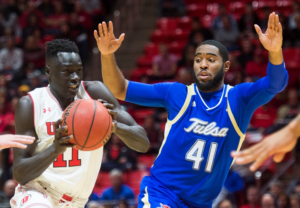 (Rick Egan  |  The Salt Lake Tribune)        Utah Utes forward Both Gach (11) takes the ball to the hoop, as Tulsa Golden Hurricane forward Jeriah Horne (41) defends, in basketball action between the Utah Utes and Tulsa Golden Hurricane at the Jon M. Huntsman Center, Saturday, Dec. 1, 2018.