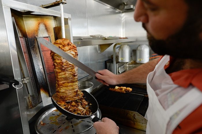 (Francisco Kjolseth  |  The Salt Lake Tribune)  Mustapha Soweidan slices chicken at Beirut Cafe, a new Lebanese restaurant in Murray.