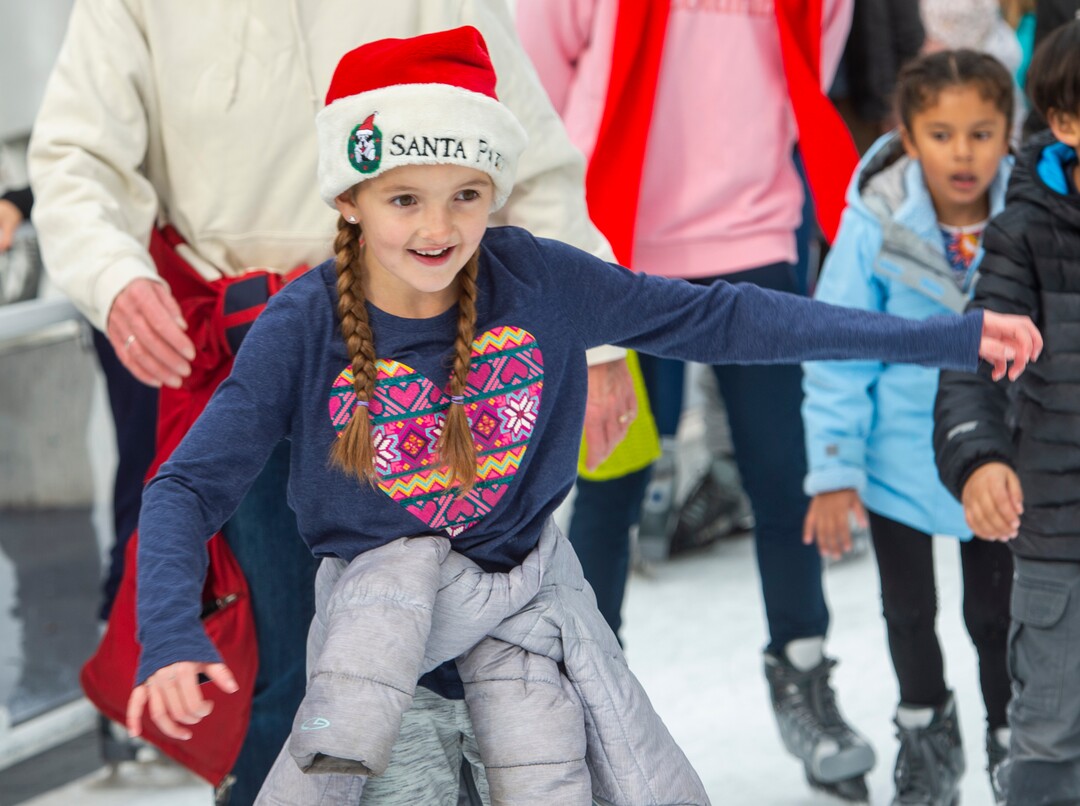 (Rick Egan  |  The Salt Lake Tribune) Leili Sloan, 7, wears her Santa Paws hat as she ice skates at the Gallivan Center on Christmas Eve, Tuesday, Dec. 24, 2019.