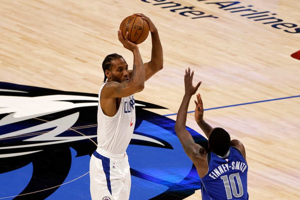 (Michael Ainsworth | AP) Los Angeles Clippers forward Kawhi Leonard (2) makes a three-point shot as Dallas Mavericks forward Dorian Finney-Smith (10) defends, in the second half during Game 6 of an NBA basketball first-round playoff series in Dallas, Friday, June 4, 2021.