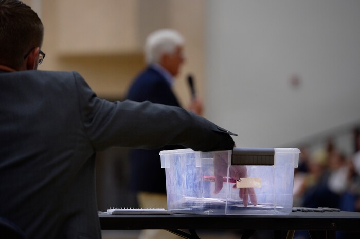 (Scott Sommerdorf   |  The Salt Lake Tribune)   
An aide picks questions from a bin during Congressman Rob Bishop's town hall meeting held at Layton Christian Academy in Layton, Utah, Friday, August 25, 2017.