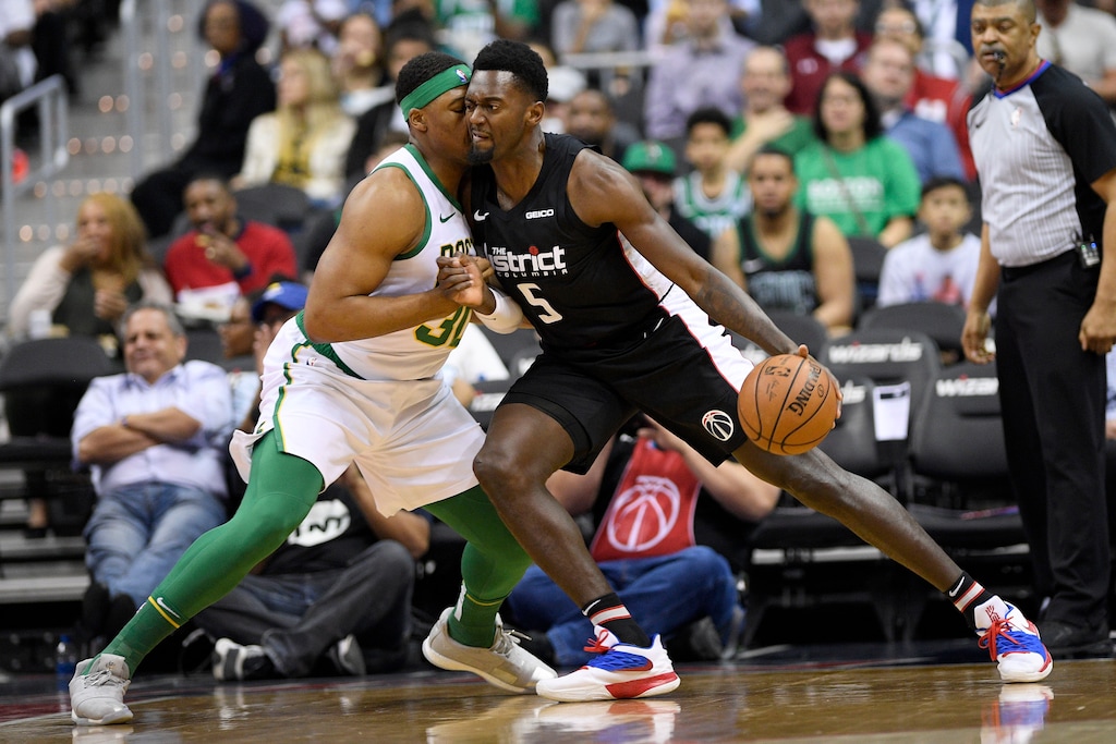 Washington Wizards forward Bobby Portis (5) dribbles the ball next to Boston Celtics forward Guerschon Yabusele during the first half of an NBA basketball game Tuesday, April 9, 2019, in Washington. (AP Photo/Nick Wass)