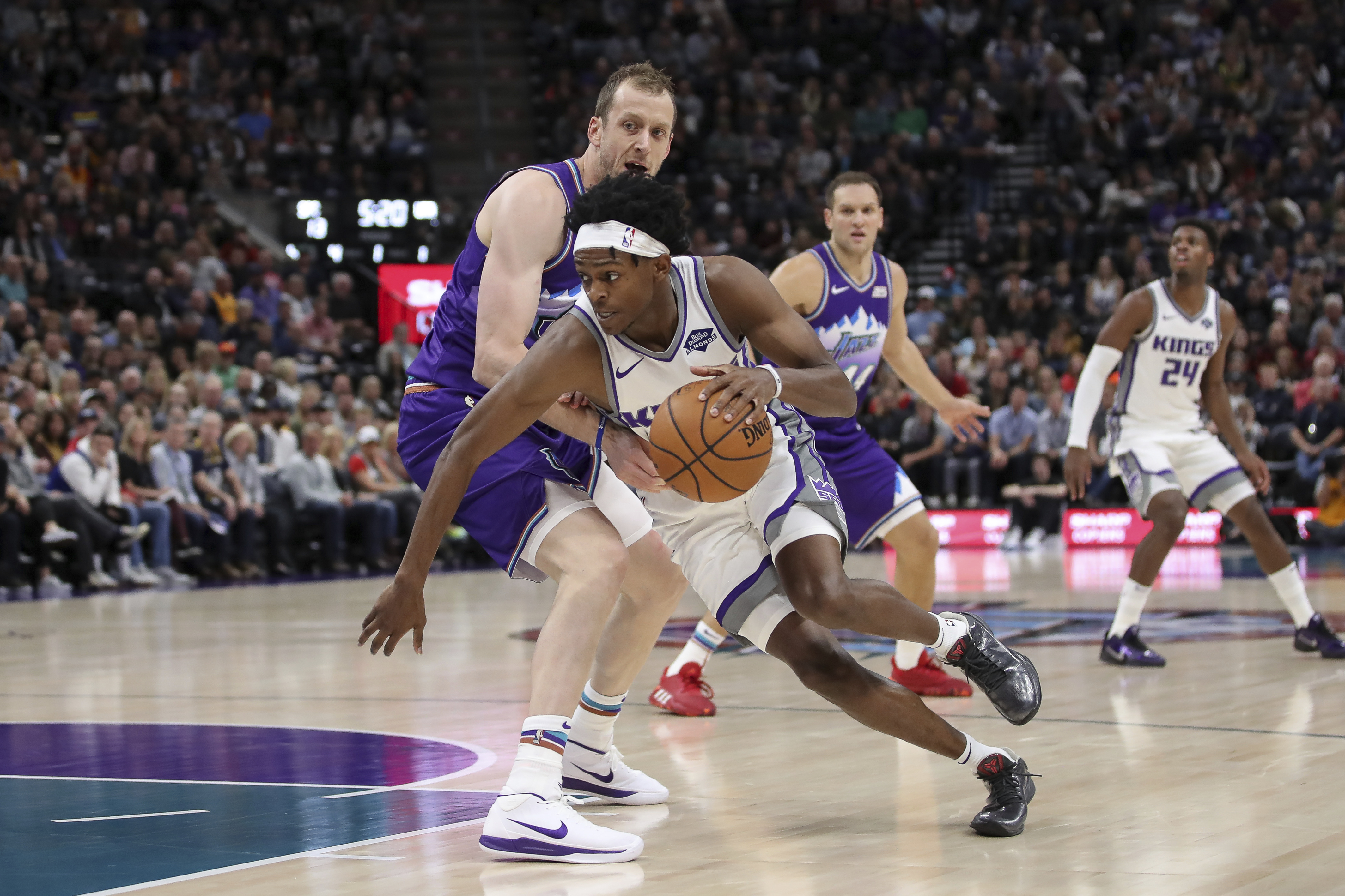 Sacramento Kings guard De'Aaron Fox (5) is fouled by Utah Jazz forward Joe Ingles (2) during the first quarter of an NBA basketball game, Saturday, Oct. 26, 2019, in Salt Lake City. (AP Photo/Chris Nicoll)