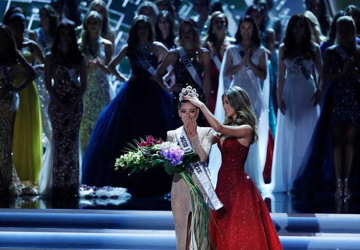 (John Locher | The Associated Press) Former Miss Universe Iris Mittenaere, right, crowns new Miss Universe Demi-Leigh Nel-Peters at the Miss Universe pageant Sunday, Nov. 26, 2017, in Las Vegas.