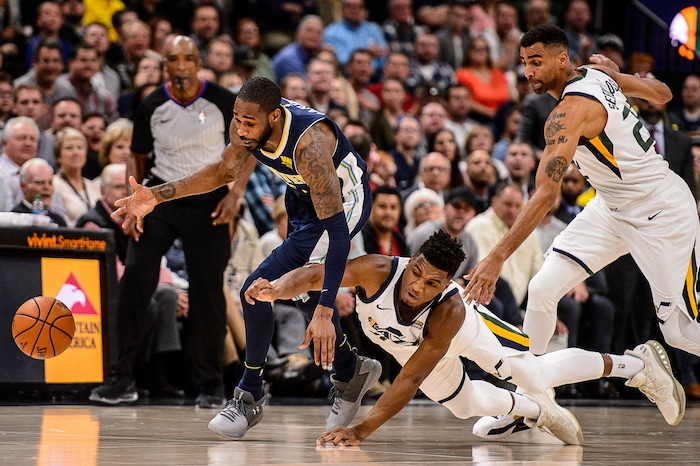 (Trent Nelson | The Salt Lake Tribune)  Denver Nuggets guard Will Barton (5) and Utah Jazz guard Donovan Mitchell (45) dive after a loose ball as the Utah Jazz host the Denver Nuggets, NBA basketball in Salt Lake City, Wednesday October 18, 2017.
