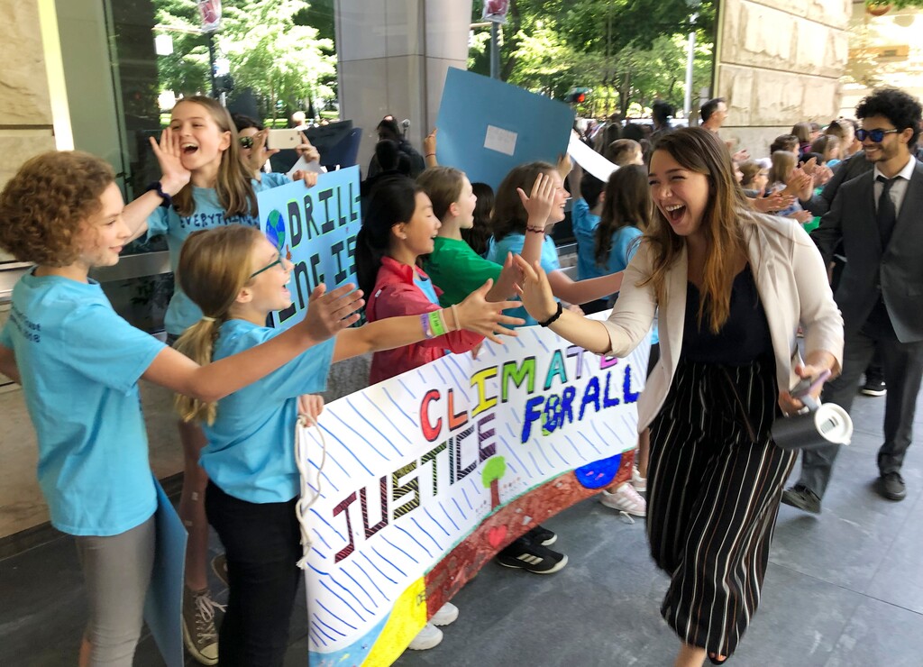 (Andrew Selsky | AP) Kelsey Juliana, of Eugene, Ore., a lead plaintiff who is part of a lawsuit by a group of young people who say U.S. energy policies are causing climate change and hurting their future, greets supporters outside a federal courthouse Tuesday, June 4, 2019, in Portland, Ore. Three judges from the 9th U.S. Circuit Court of Appeals are hearing arguments from lawyers for 21 young people and the federal government in Portland but are not expected to rule right away. The Obama and Trump administrations have tried to get the lawsuit dismissed since it was filed in Oregon in 2015.