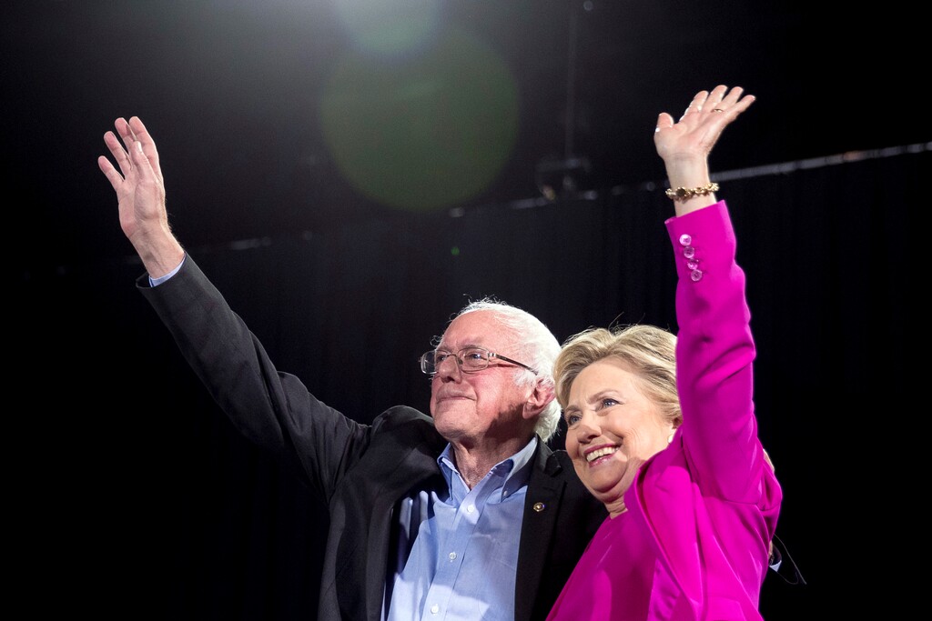 (Andrew Harnik | AP file photo) In this Nov. 3, 2016, file photo, Democratic presidential candidate Hillary Clinton and Sen. Bernie Sanders, I-Vt., appear on stage at a rally in Raleigh, N.C.