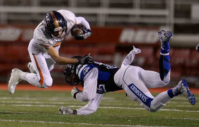 (Francisco Kjolseth  |  The Salt Lake Tribune)  Jace Dart of Mountain Crest is tackled by Tavita Gagnier of Stansbury in their class 4A semifinal game at Rice-Eccles Stadium,Thursday, Nov. 9, 2017.