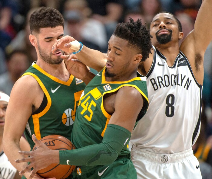 (Rick Egan  |  The Salt Lake Tribune)  Brooklyn Nets guard Spencer Dinwiddie (8) tries to keep the ball from Utah Jazz guard Donovan Mitchell (45) as he takes a hand off from Utah Jazz forward Georges Niang (31), in NBA action between Utah Jazz and Brooklyn Nets, at  Vivint Smart Home Arena, Saturday, March 17, 2019.



