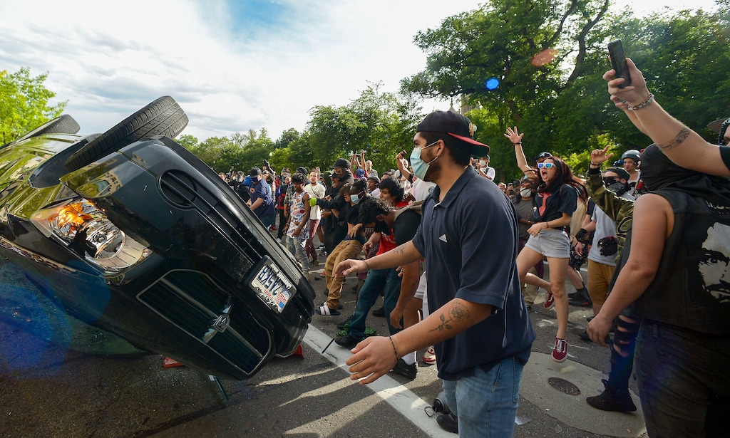 (Leah Hogsten  |  The Salt Lake Tribune)  Protesters turn over a car belonging to Brandon McCormick and set it on fire. Hundreds march in downtown Salt Lake City overturning two police cars and setting them on fire on Saturday, May 30, 2020, to protest the death of George Floyd, who died earlier this week after a Minneapolis police officer knelt on his neck.