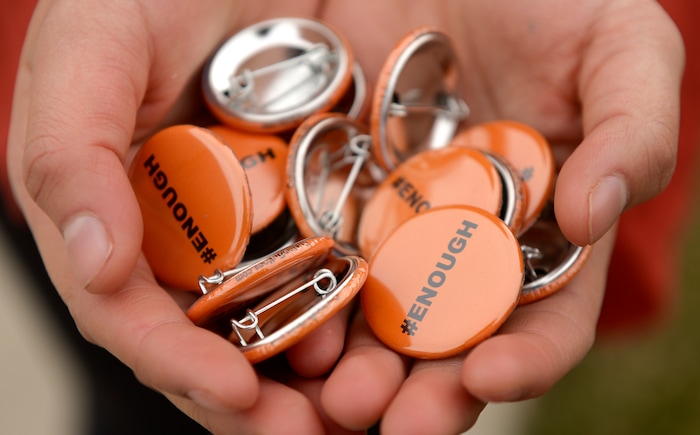 (Leah Hogsten  |  The Salt Lake Tribune) Students at East High School distributed #Enough pins in a call for action. Exactly one month after 17 people were killed at Marjory Stoneman Douglas High School in Parkland, survivors of the massacre joined tens of thousands of students across the United States by walking out of school,  Wednesday, March 14, 2018. 