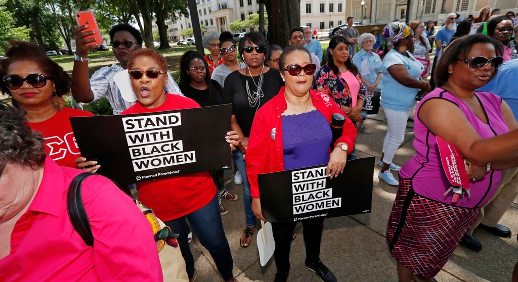 Abortion rights advocates gather. Tuesday, May 21, 2019, at the Capitol in Jackson, Miss., as they rally to voice their opposition to state legislatures passing abortion bans. (AP Photo/Rogelio V. Solis)