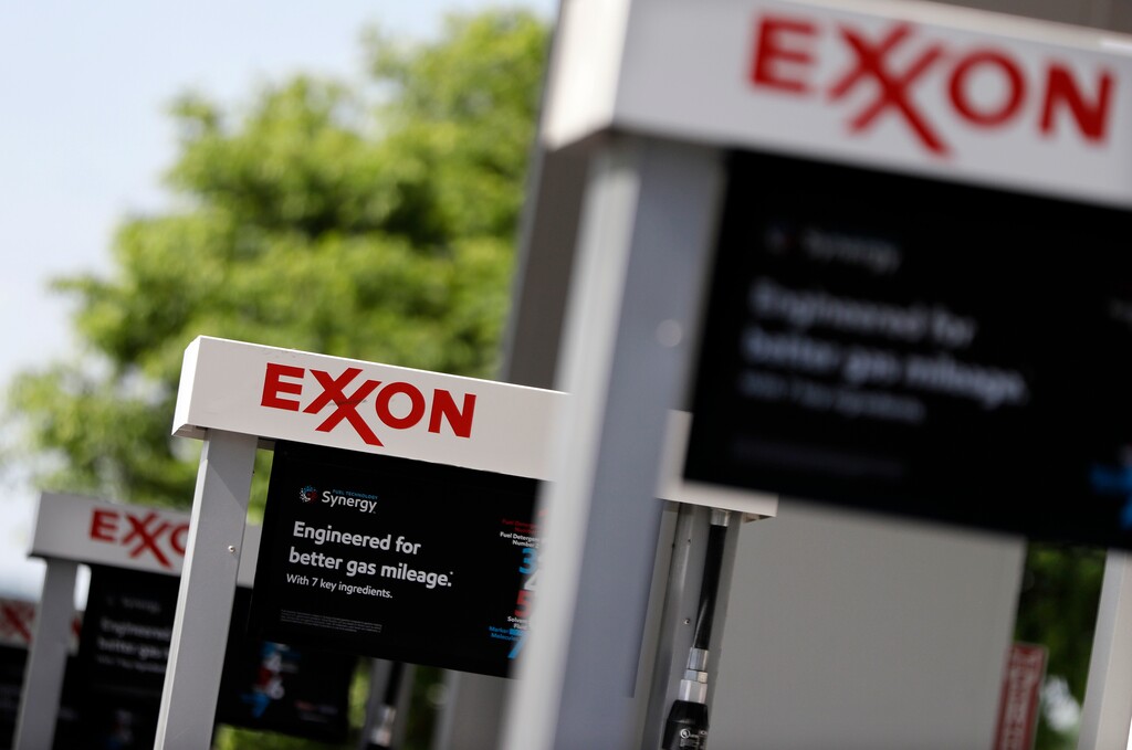This April 25, 2017, photo, shows Exxon service station signs in Nashville, Tenn. Exxon Mobil Corp. reports earnings, Friday, July 28, 2017. (AP Photo/Mark Humphrey)