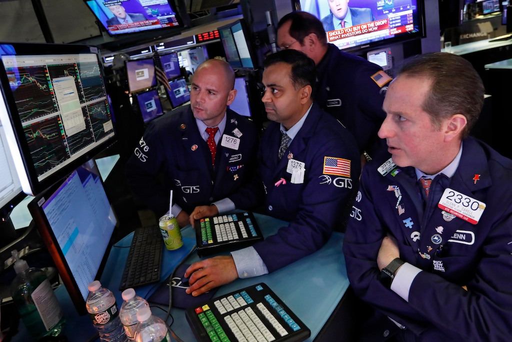 (Richard Drew | AP) Specialists Mario Picone, Dilip Patel and Glenn Carrel, left to right, work on the floor of the New York Stock Exchange, Tuesday, Feb. 25, 2020. U.S. stocks fell in midday trading Tuesday, a day after the market's biggest drop in two years, as traders worry that the spreading coronavirus will threaten global economic growth.