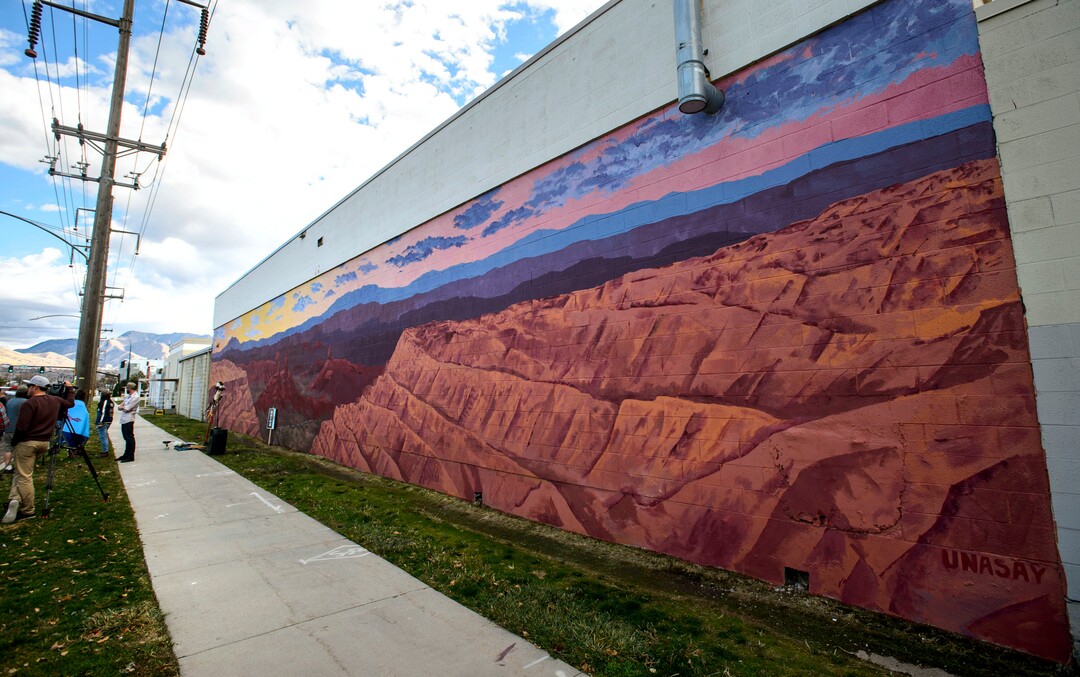 (Steve Griffin  |  The Salt Lake Tribune) Utah graphic artist Josh Scheuerman stands in front of his mural of landscapes from Bears Ears National Monument during a dedication ceremony on 800 South near 300 West in Salt Lake City on Friday, Nov. 24, 2017.