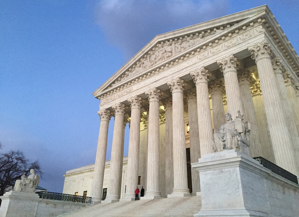 FILE - In this Feb. 13, 2016, file photo, people stand on the steps of the Supreme Court at sunset in Washington.The Supreme Court is stopping Louisiana from enforcing new regulations on abortion clinics in a test of the conservative court’s views on abortion rights. (AP Photo/Jon Elswick, File)