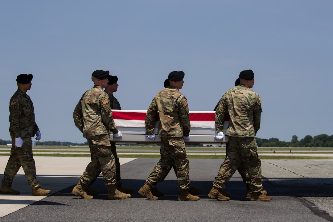 (Alex Brandon  |  AP Photo) An Army carry team moves a transfer case containing the remains of U.S. Army Sgt. 1st Class Elliott J. Robbins, at Dover Air Force Base, Del., Tuesday, July 2, 2019. According to the Department of Defense, Robbins, of Ogden, Utah, assigned to the 10th Special Forces Group died while supporting Operation Freedom's Sentinel.