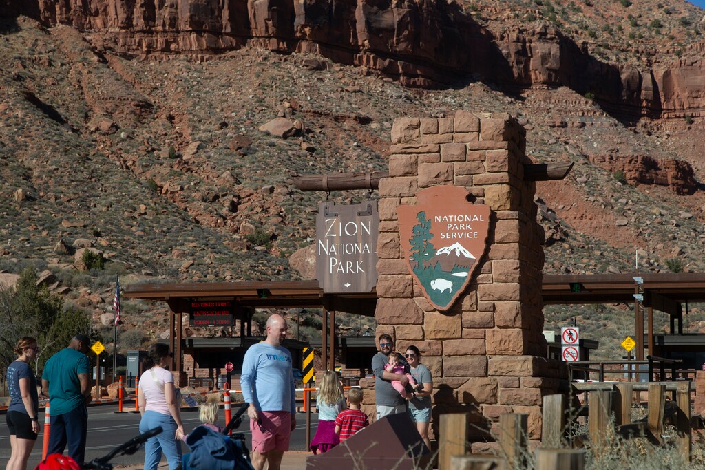 (Chris Caldwell | Special to The Tribune) Zion National Park visitors pose for photos at the south entrance Saturday, March 1, 2025.