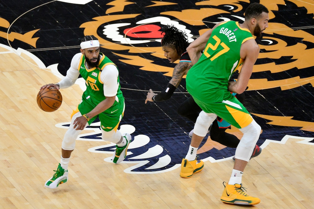 Utah Jazz guard Mike Conley (10) drives past Memphis Grizzlies guard Ja Morant with help from center Rudy Gobert (27) during the first half of an NBA basketball game Wednesday, March 31, 2021, in Memphis, Tenn. (AP Photo/Brandon Dill)