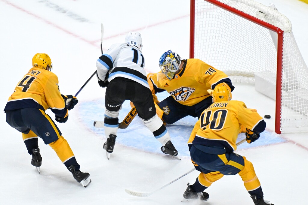 (John Amis | AP) Utah Mammoth right wing Dylan Guenther (11) scores on Nashville Predators goaltender Juuse Saros (74) during overtime in an NHL hockey game Saturday Oct. 11, 2025, in Nashville, Tenn.