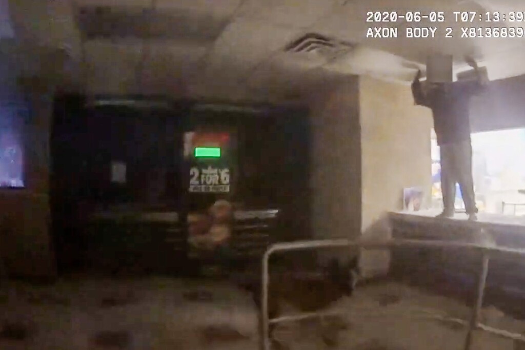 (Screenshot via Salt Lake City Police Department/YouTube) Police body camera footage from June 5, 2020, shows a 14-year-old boy, who was a burglary suspect, with his hands in the air before a Salt Lake City police officer pulled him off a counter and ordered a police dog to bite him.