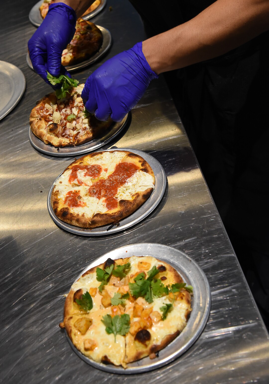 (Francisco Kjolseth  |  The Salt Lake Tribune)  Alex Sanchez assembles the lunch special, kids sized pizza with a side salad at Wicked Peel Pizza Kitchen in Riverton.