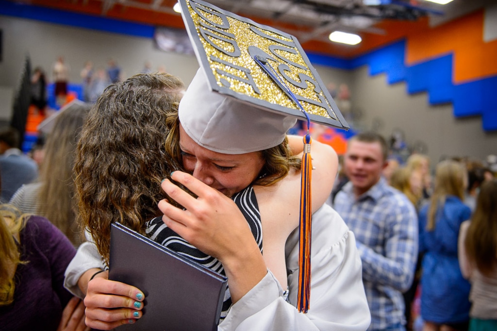 (Trent Nelson | Tribune file photo) Water Canyon High School graduate Danielle Barlow breaks down in tears in the arm of a friend, Paula Barlow, after a graduation ceremony in Hildale, Monday May 22, 2017. Barlow is the 13th of 16 children, and the first to earn a high school diploma.