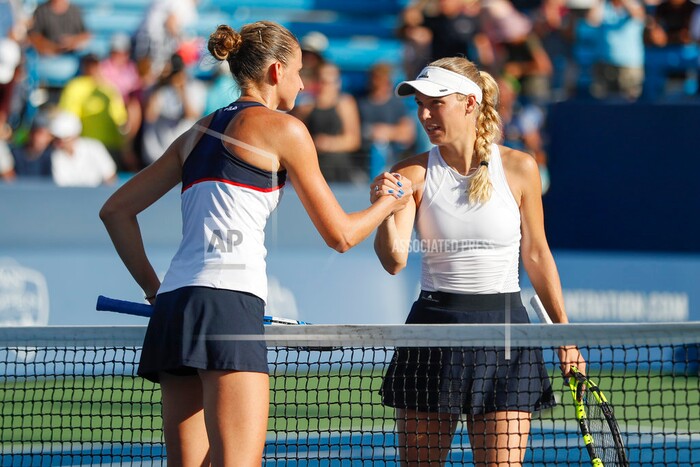 Karolina Pliskova, left, of the Czech Republic, shakes hands with Caroline Wozniacki, of Denmark, after winning their match at the Western & Southern Open tennis tournament, Friday, Aug. 18, 2017, in Mason, Ohio. (AP Photo/John Minchillo)