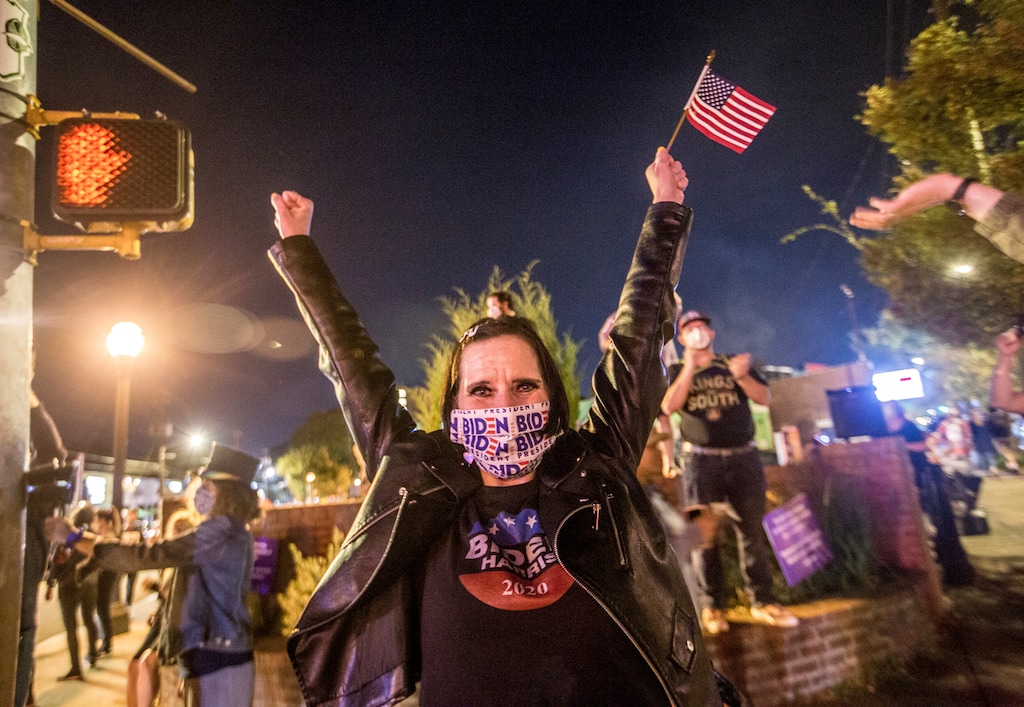 Angie Whitworth Pace of Tucker, Ga., reacts to election results favoring President-elect Joe Biden and Vice President-elect Kamala Harris in East Atlanta on Saturday, Nov 7, 2020. (Jenni Girtman/Atlanta Journal-Constitution via AP)