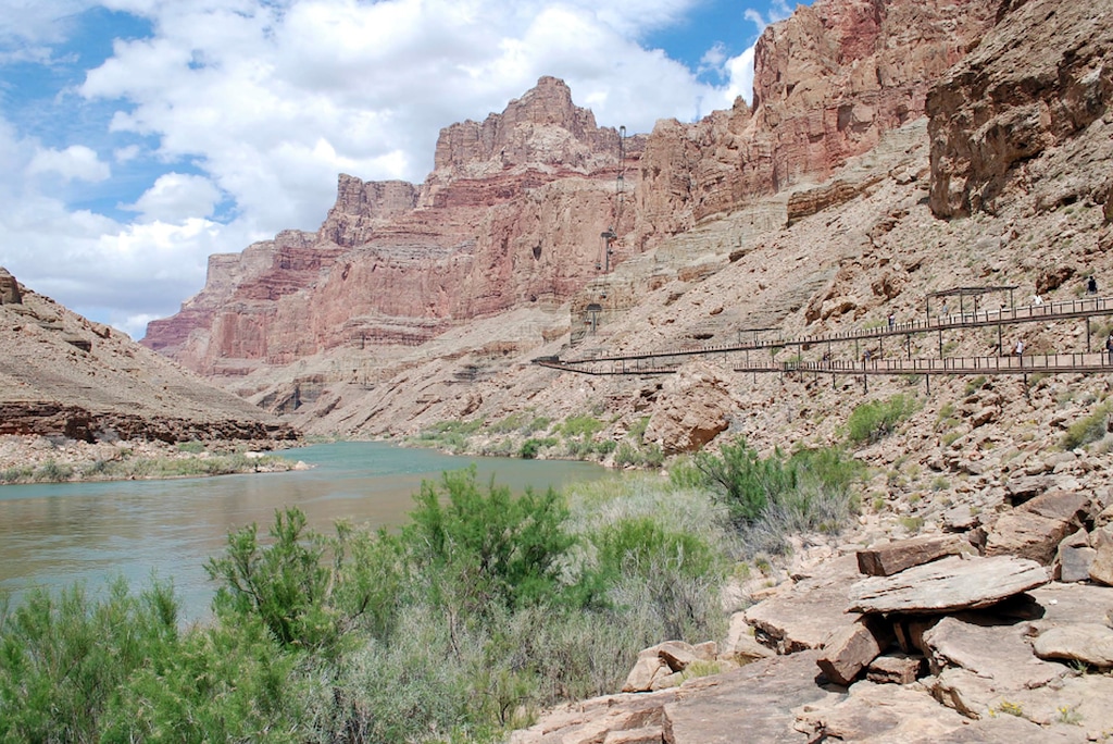 This artist rendering provided by Confluence Partners, LLC, depicts a proposed aerial tramway, at right, that would ferry tourists from the cliff tops of the east rim of the Grand Canyon to the water's edge of the Colorado and Little Colorado Rivers below. (Confluence Partners, LLC via AP)