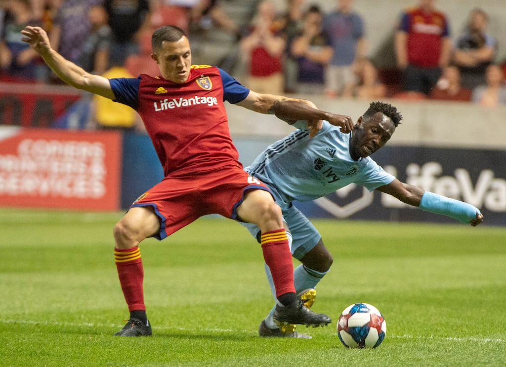 (Rick Egan  |  The Salt Lake Tribune)  Real Salt Lake defender Aaron Herrera (22) and Sporting Kansas City forward Gerso (12) go for the ball, in MLS action between Real Salt Lake and Sporting Kansas City, in Sandy, Saturday, June 29, 2019.