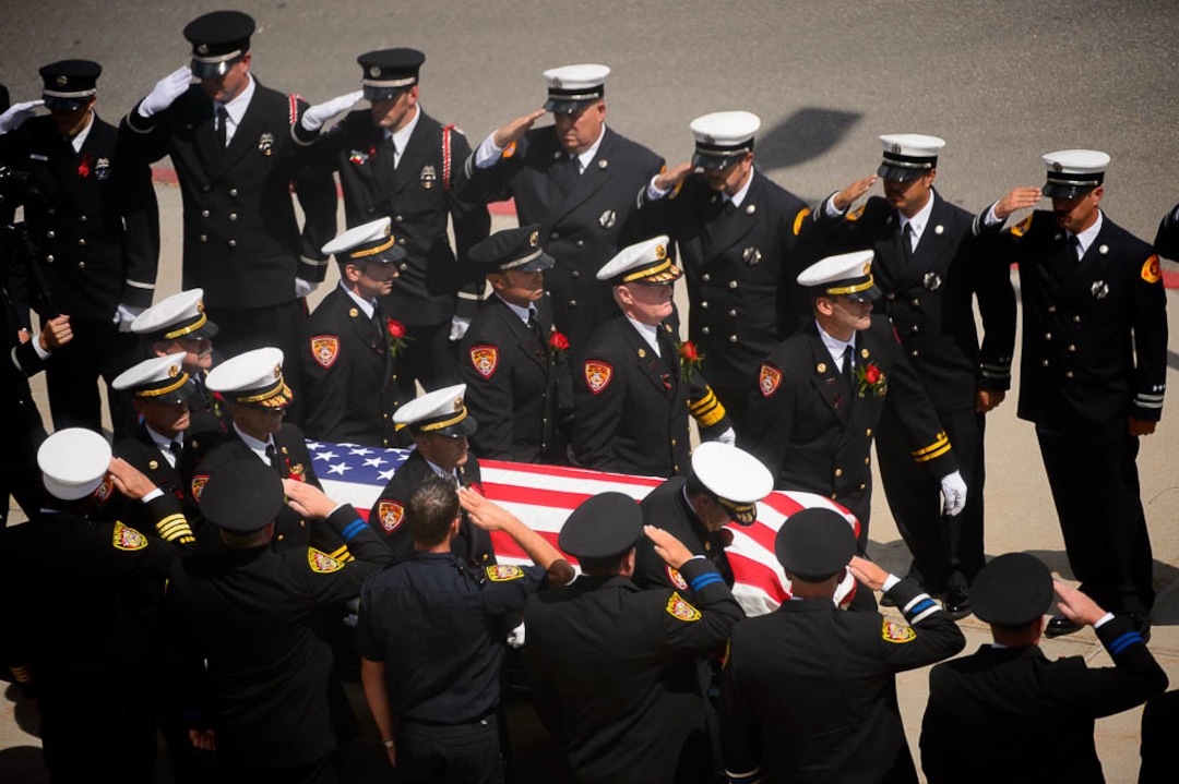 (Trent Nelson | The Salt Lake Tribune)  Funeral services for Battalion Chief Matthew Burchett at the Maverik Center in West Valley City, Monday Aug. 20, 2018.