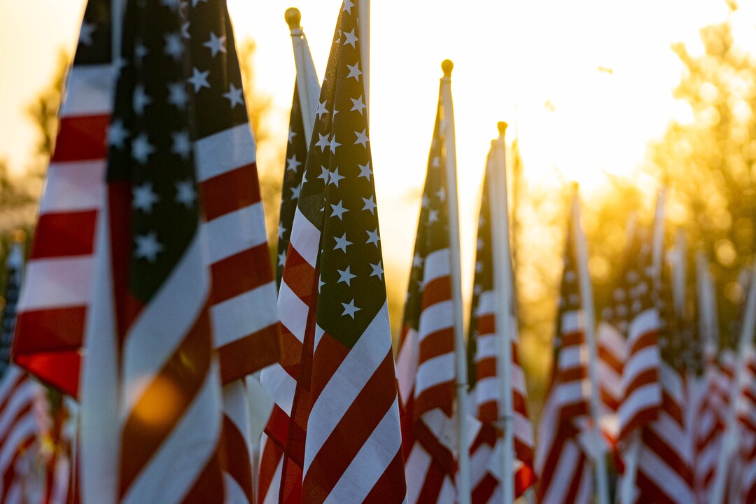 (Francisco Kjolseth | The Salt Lake Tribune) The sun rises on Saturday, Sept. 11, 2021, as people visit the Utah Healing Field in Sandy, part of the nonprofit Colonial Flag Foundation, who posted 3,000 flags to honor the fallen. The display is free to the public and open now through Sept. 13.