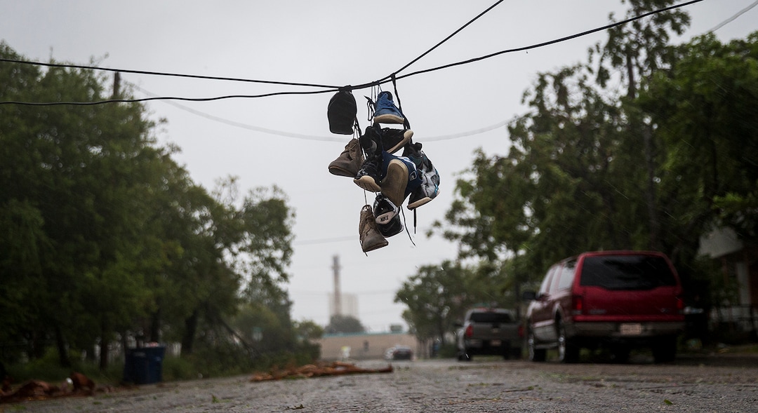 (Nick Wagner | Austin American-Statesman via AP) Shoes tied to a power line hang near a street after winds from Hurricane Harvey brought down a power pole in Corpus Christi, Texas, on Friday, Aug. 25, 2017. Hurricane Harvey smashed into Texas late Friday, lashing a wide swath of the Gulf Coast with strong winds and torrential rain from the fiercest hurricane to hit the U.S. in more than a decade.