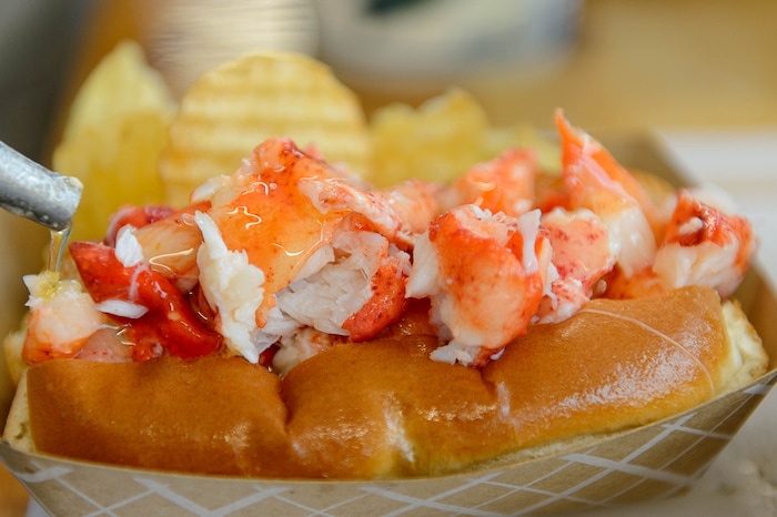 (Trent Nelson | The Salt Lake Tribune) A lobster roll gets a layer of hot butter at Freshie's Lobster Co. in Park City.